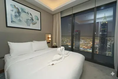 a hotel room with a bed with a towel on it at Address Residences Dubai Opera - Boulevard Views 1 & 2 Bedroom Apartment 5 minute walk to Burj Khalifa & Dubai Mall by NAMUVE in Dubai