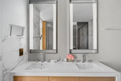 a bathroom with two sinks and two mirrors at Address Residences Dubai Opera - Boulevard Views 1 & 2 Bedroom Apartment 5 minute walk to Burj Khalifa & Dubai Mall by NAMUVE in Dubai