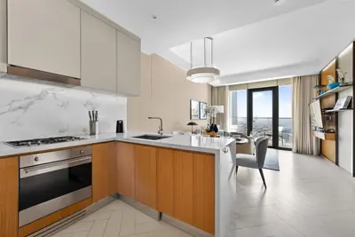 a kitchen with a sink and a stove top oven at Address Residences Dubai Opera - Boulevard Views 1 & 2 Bedroom Apartment 5 minute walk to Burj Khalifa & Dubai Mall by NAMUVE in Dubai