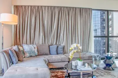 a living room with a couch and a glass table at 2BR - DAMAC Towers by Paramount - Business Bay in Dubai