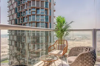 a balcony with chairs and a table and a building at 2BR - DAMAC Towers by Paramount - Business Bay in Dubai