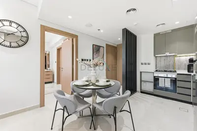 a kitchen and dining room with a table and chairs at Minutes from Dubai Marina with Easy Access to Sheikh Mohammed Bin Zayed Road - Cloud Tower A, Jumeirah Village Triangle by Deluxe Holiday Homes in Dubai