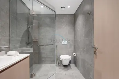 a bathroom with a shower with a toilet and a sink at Minutes from Dubai Marina with Easy Access to Sheikh Mohammed Bin Zayed Road - Cloud Tower A, Jumeirah Village Triangle by Deluxe Holiday Homes in Dubai