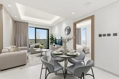 a living room with a table and chairs at Minutes from Dubai Marina with Easy Access to Sheikh Mohammed Bin Zayed Road - Cloud Tower A, Jumeirah Village Triangle by Deluxe Holiday Homes in Dubai