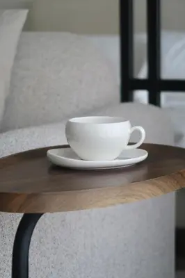 a white coffee cup on a wooden table at Designed 2BR in Socio Dubai Hills in Dubai