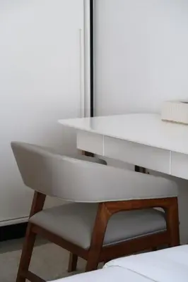 a white desk and a chair in a room at Designed 2BR in Socio Dubai Hills in Dubai