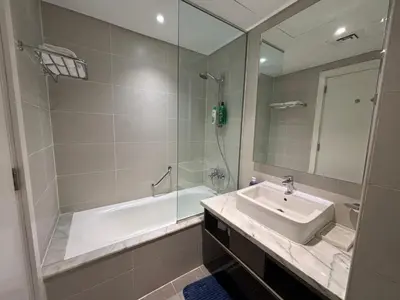 a bathroom with a tub and a sink and a shower at Contemporary Studio in Business Bay - Burj Khalifa View - Gym & Pool in Dubai