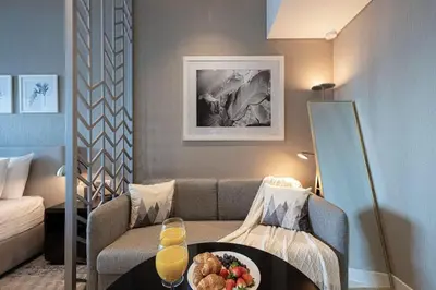 a living room with a couch and a table with a plate of food at Contemporary Studio in Business Bay - Burj Khalifa View - Gym & Pool in Dubai