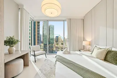 a bedroom with a bed and a large window at High-Floor 1BR Facing the Marina and City, Minutes from Marina Beach with Easy Access to Marine Transport, LIV Marina, Dubai Marina by Deluxe Holiday Homes in Dubai