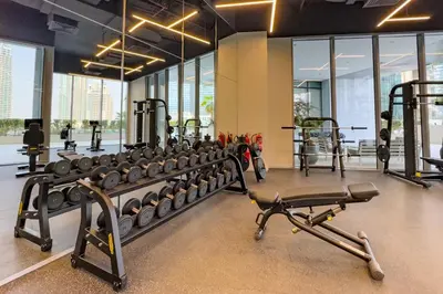 a gym with a lot of treadmills and weights at High-Floor 1BR Facing the Marina and City, Minutes from Marina Beach with Easy Access to Marine Transport, LIV Marina, Dubai Marina by Deluxe Holiday Homes in Dubai