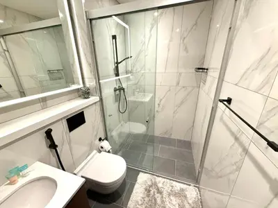 a bathroom with a shower and a toilet and a sink at Spacious apartment with Burj Khalifa view close to Dubai mall! in Dubai