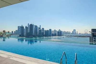 a swimming pool with a city skyline in the background at Seven Palm Residence with Beach access in Dubai