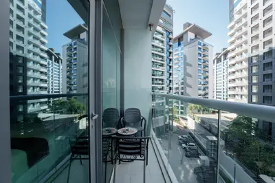 a balcony with a table and chairs on it at Seven Palm Residence with Beach access in Dubai