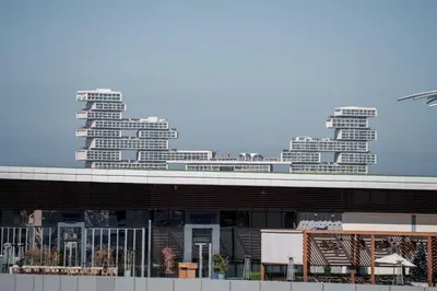 a view of a building with tall buildings in the background at Seven Palm Residence with Beach access in Dubai
