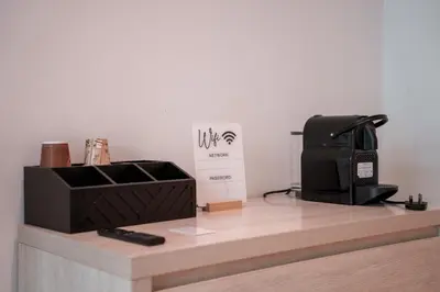 a counter with a microwave and a box on it at Seven Palm Residence with Beach access in Dubai
