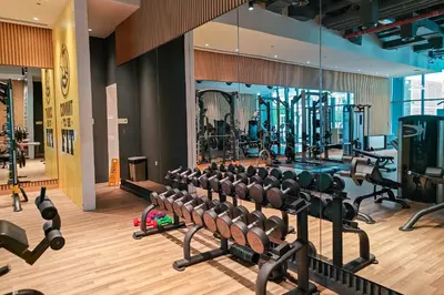 a gym with rows of treadmills and machines at Seven Palm Residence with Beach access in Dubai
