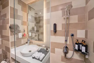 a bathroom with a sink and a shower at Seven Palm Residence with Beach access in Dubai