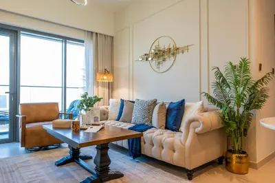 a living room with a couch and a table at Stunning 1 Bedroom Panoramic Views at Burj Royale in Dubai