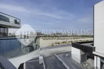 a view of the beach from the balcony of a building at Bloomfields Classic 2Br With Private Pool Samana in Dubai