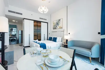 a hotel room with a bed and a dining table at Opalz by Danube,Dubai Science Park - Studio Apartment - Allsopp & Allsopp in Dubai