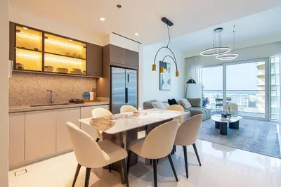 a kitchen and dining room with a table and chairs at Skyline Serenity - Luxury Beachfront Living in Dubai