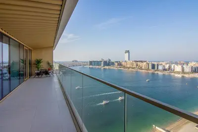 a balcony of a building with a view of the water at Skyline Serenity - Luxury Beachfront Living in Dubai