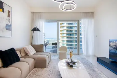 a living room with a couch and a table at Skyline Serenity - Luxury Beachfront Living in Dubai