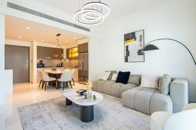 a living room with a couch and a table at Skyline Serenity - Luxury Beachfront Living in Dubai