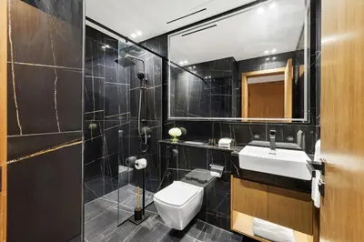 a bathroom with a toilet and a sink and a shower at BLVD Luxury 2BHK with Private Pool Near Circle Mall in Dubai