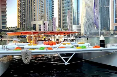 a boat in a body of water with buildings at Marina Residence tower A in Dubai