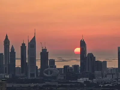 a city skyline with the sun setting in the background at Address Point Tower 2 in Dubai