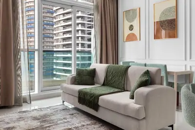 a living room with a couch and a large window at Modern 2BR Luxury Apartment with Downtown Dubai & Burj Khalifa Views in Dubai