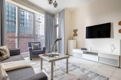 a living room with a couch and a tv at Frank Porter - Torch Tower Marina in Dubai