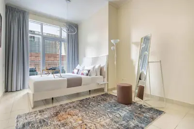 a bedroom with a white bed and a large window at Frank Porter - Torch Tower Marina in Dubai