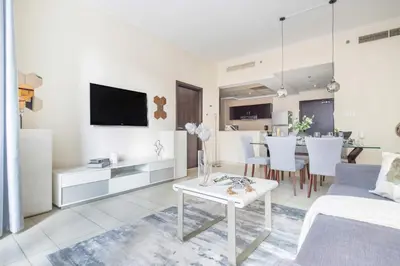 a white living room with a white couch and a table at Frank Porter - Torch Tower Marina in Dubai
