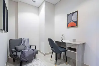a office with a chair and a desk in a room at Frank Porter - Golf Gate 1 in Dubai
