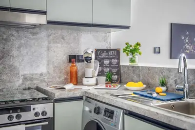 a kitchen with a sink and a counter top at Frank Porter - Golf Gate 1 in Dubai