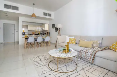 a living room with a couch and a table at Frank Porter - Polo Residence C5 in Dubai