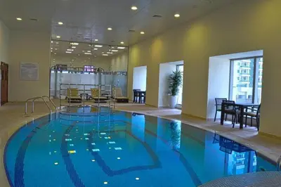 a large swimming pool in a hotel room at Marina Princess Tower Dubai Apartment in Dubai