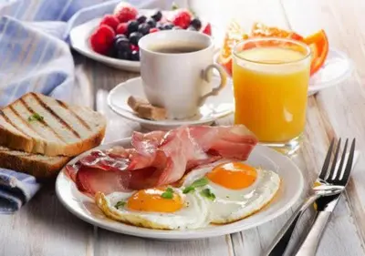 a breakfast plate with eggs and toast and a cup of coffee at Marina Princess Tower Dubai Apartment in Dubai