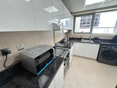 a kitchen with a microwave on a counter with a sink at Luxury Apartment Fully Furnished Jumeirah Garden City in Dubai