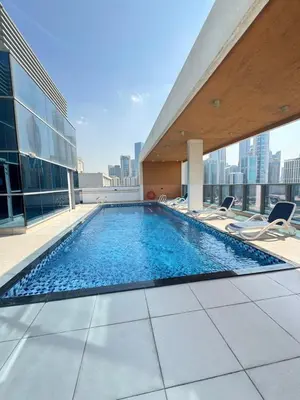 a swimming pool on the roof of a building at Luxury Apartment Fully Furnished Jumeirah Garden City in Dubai