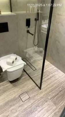 a bathroom with a toilet and a glass shower at MARINA VIEW TOWER a WING in Dubai