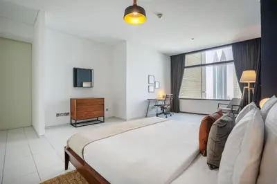 a bedroom with a large bed and a television at Blueground DIFC pool gym DXB-505 in Dubai