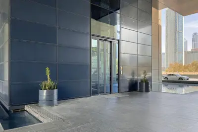 a building with two potted plants on the side of it at Blueground DIFC pool gym DXB-505 in Dubai