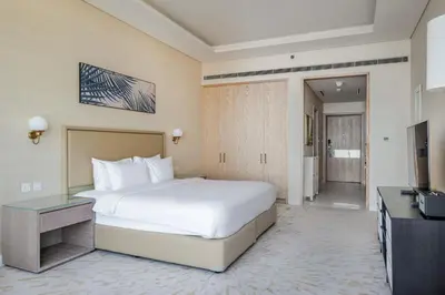a hotel room with a bed and a television at Blueground The Palm Jumeirah pool nr Atlantis DXB-1712 in Dubai