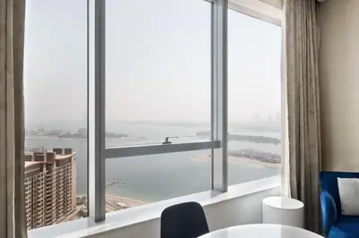 a room with a large window with a view of the water at Blueground The Palm Jumeirah jacuzzi nr Atlantis DXB-1708 in Dubai
