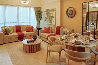 a living room with a couch and a table at Rare apt with views of both Marina and JBR wheel in Dubai