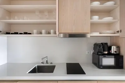 a kitchen with a sink and a microwave at Blueground The Palm Jumeirah pool nr Marina DXB-1711 in Dubai