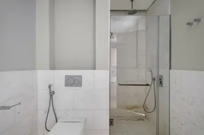 a bathroom with a shower with a toilet and a sink at Blueground The Palm Jumeirah pool nr Marina DXB-1711 in Dubai